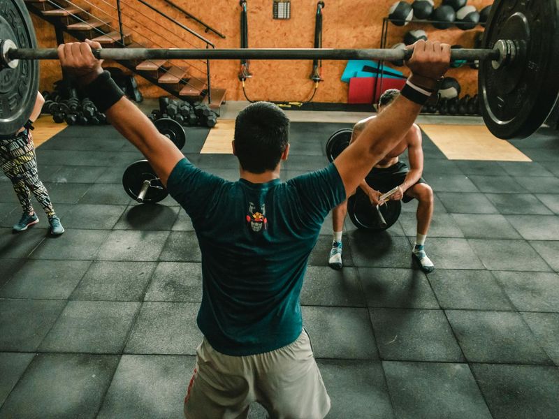 Detailed view of gym weights and athlete hands