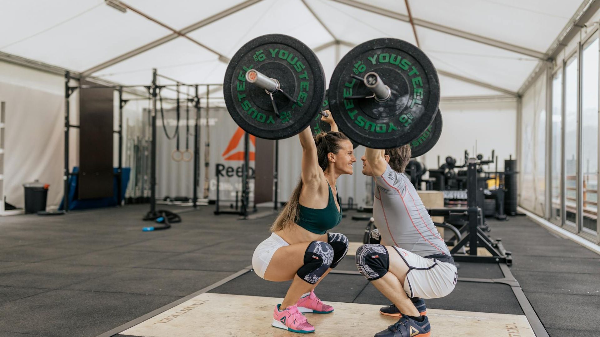 Strong man performing heavy lifting in a dark gym